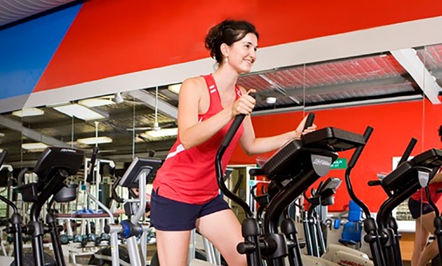 大发体育在线健身中心，一名女子在跑步机上锻炼.