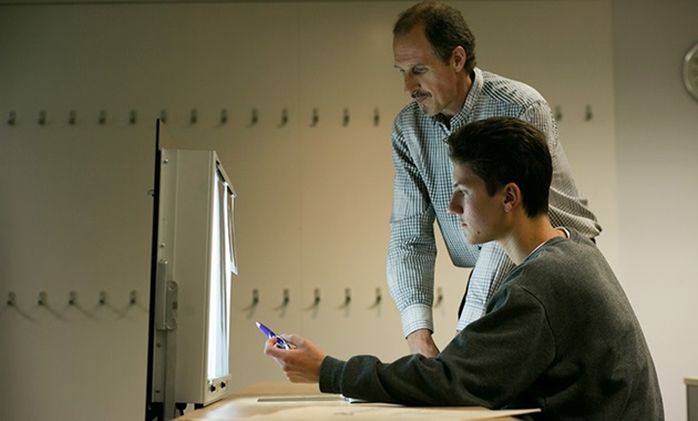 Two researchers looking at xray light box