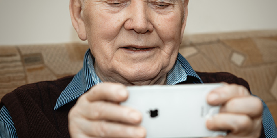 Elderly man using iPhone