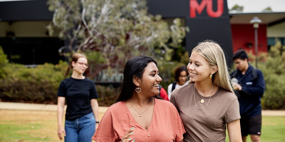 A group of students laughing and chatting on Bush Court