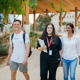 Three Murdoch students walking outside Boola Katitjin smiling