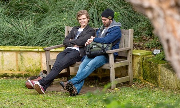 2 men sitting on a bench