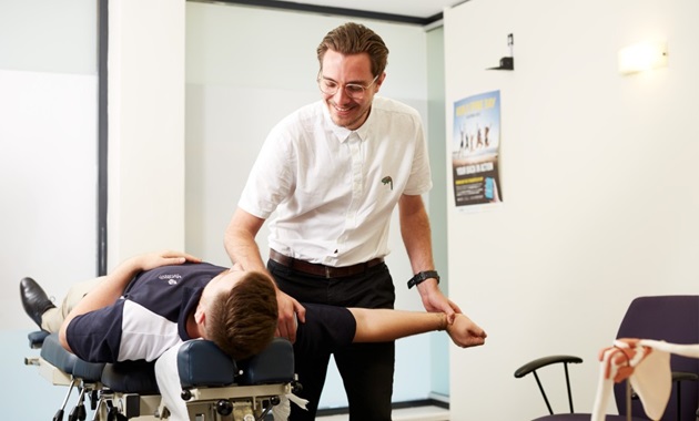 Chiropractor manipulating a client's arm