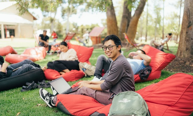 Male student sitting on beanbag on Bush Court