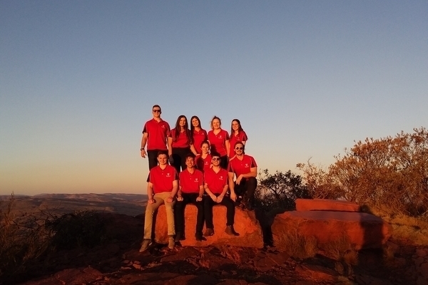outreach clinic support staff sitting on a rock in the bush