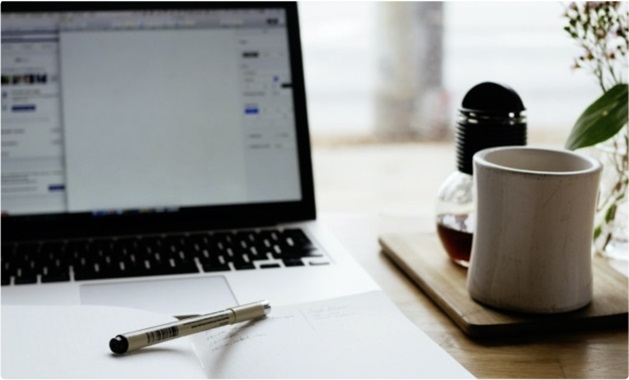 laptop, pen and coffee mug