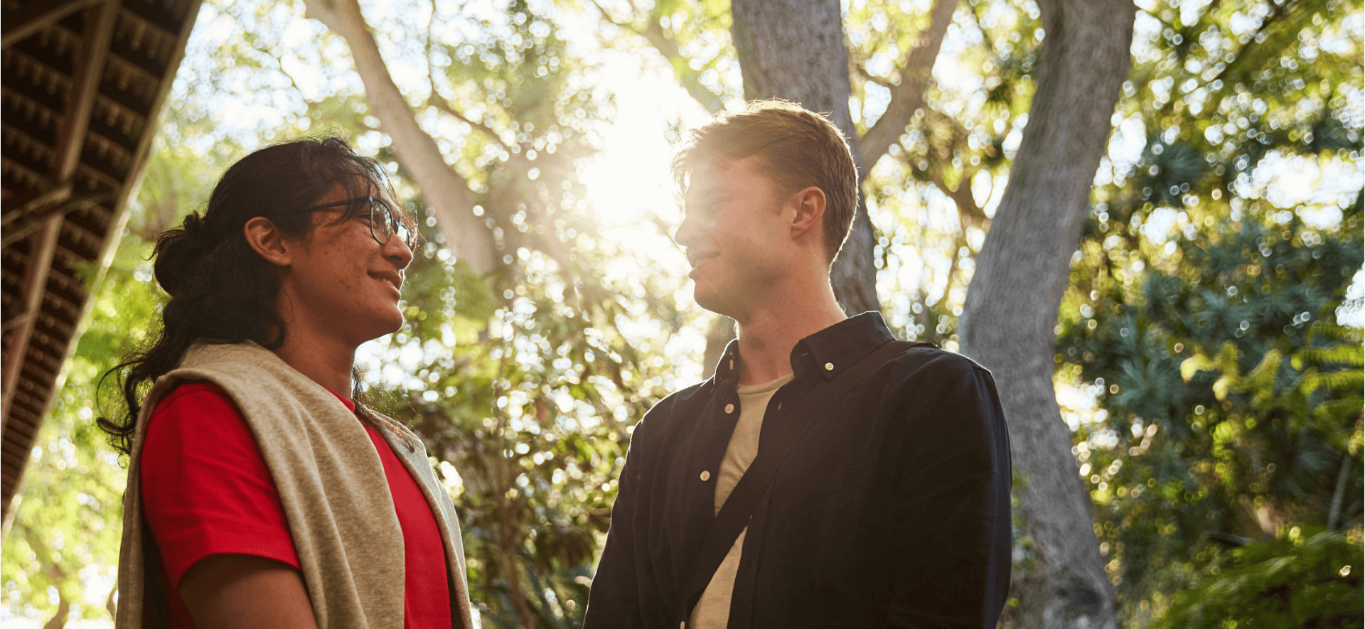 2 male students in front of trees and sunlight