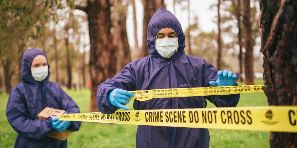 male and female forensic students at a crime scene