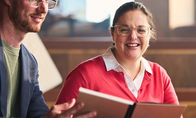 Staff looking at a textbook