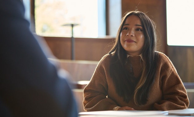 Student sitting at table with notes