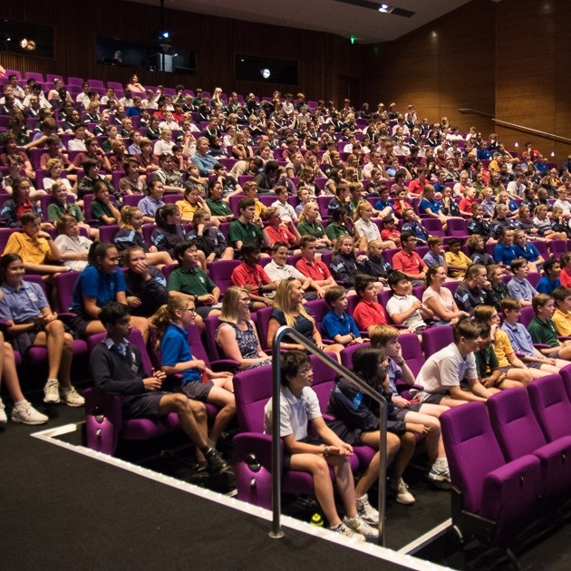 High school students sitting in a large lecture theatre