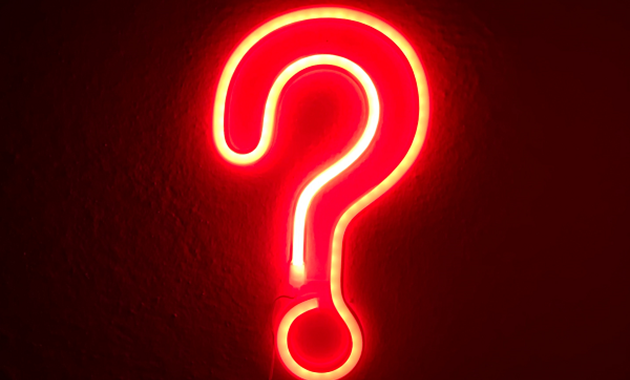 Orange neon sign in the shape of a question mark