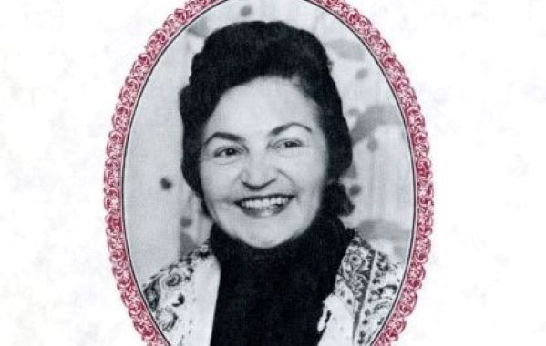 sepia image of a woman with dark hair piled on her head and a large smile