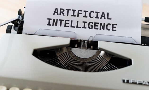 Old manual typewriter with the words "artificial intelligence" typed on the paper
