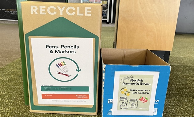 boxes with signs to collect jars and pens for recycling