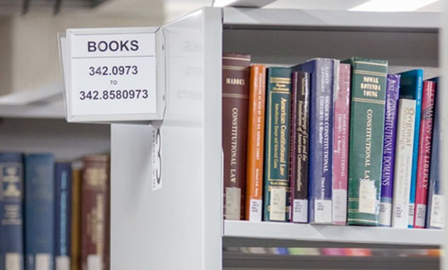 Library shelves with sign showing books and call number