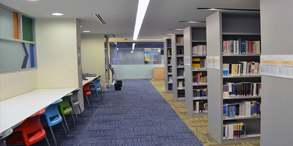 Study desks and book collections at Kaplan Singapore library