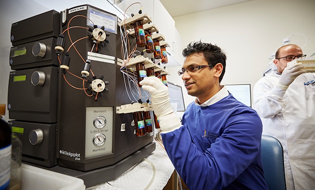 Researcher in lab using research machinery