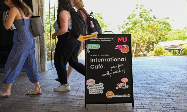 A sign outside a café with the words "International Café" written on it.