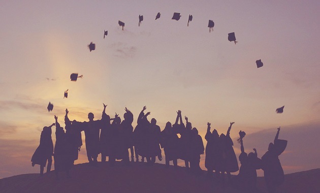 Graduates throwing hats in the air