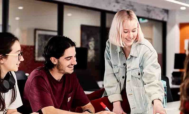 Group of people studying at a desk