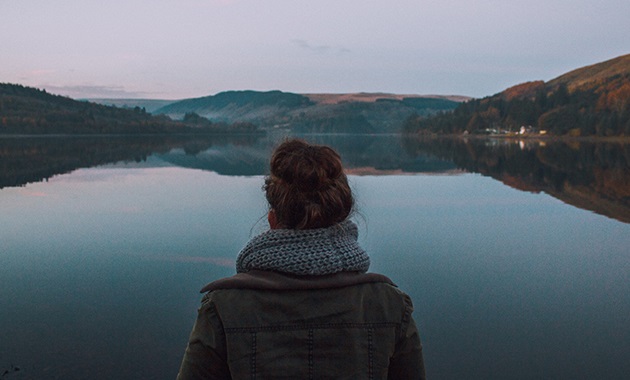 Girl standing in front of a lake