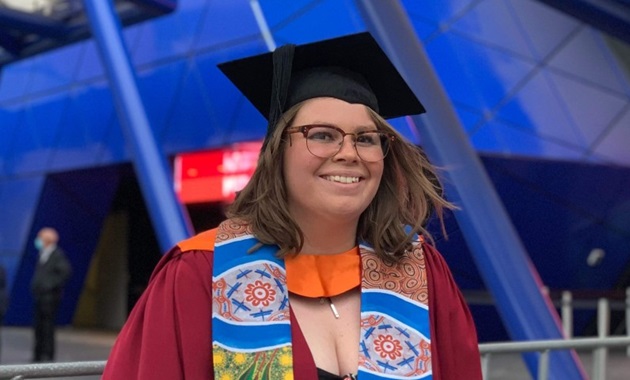 Recent Kulbardi and Murdoch graduate, Sasha Ihms smiling at the camera in front of RAC Arena.