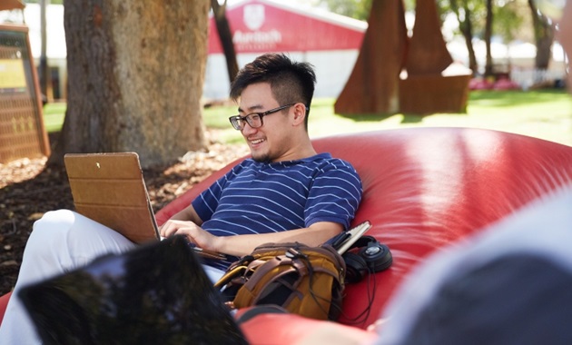 man studying in bush court