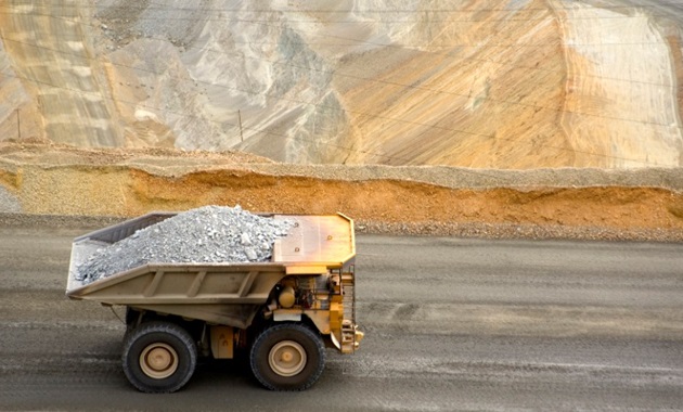 mining dump truck drives through copper mine