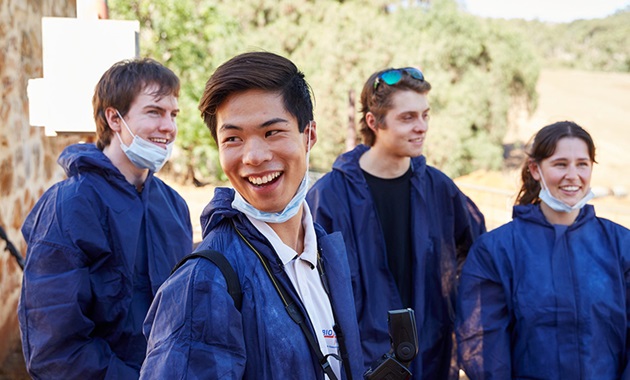 Murdoch students in the field wearing protective gear.