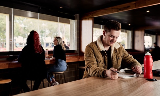 student studying at bar