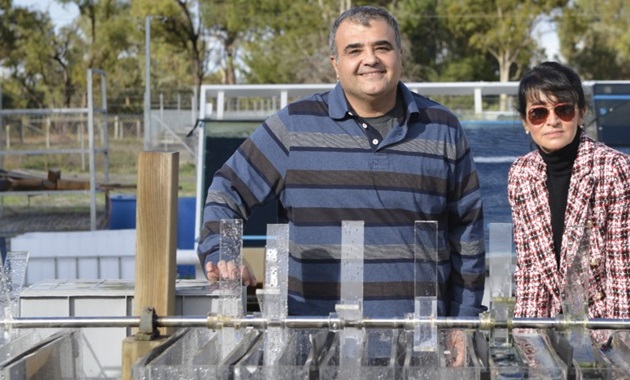 Parisa Bahri and Navid Moheimani beside water research vessels