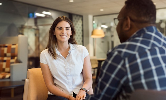 Female student smiles sitting in psychology clinic.