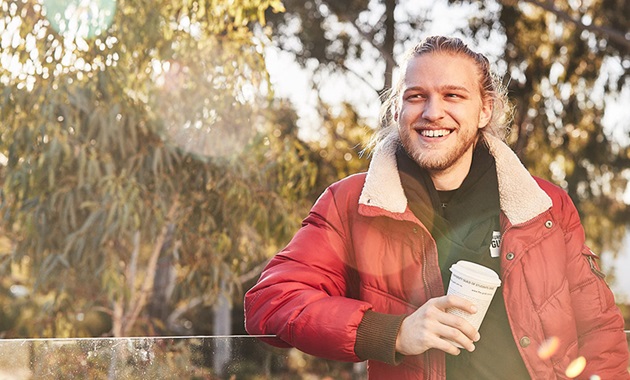 Murdoch student wearing red jacket and smiling