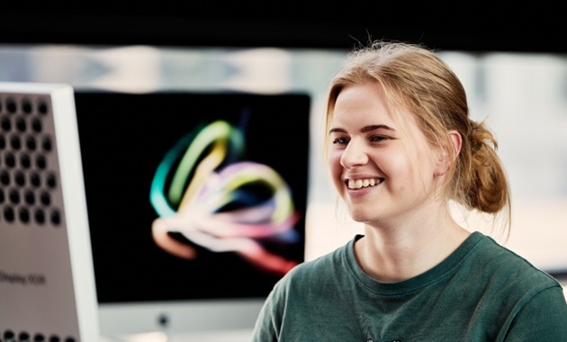 Woman at computer, smiling