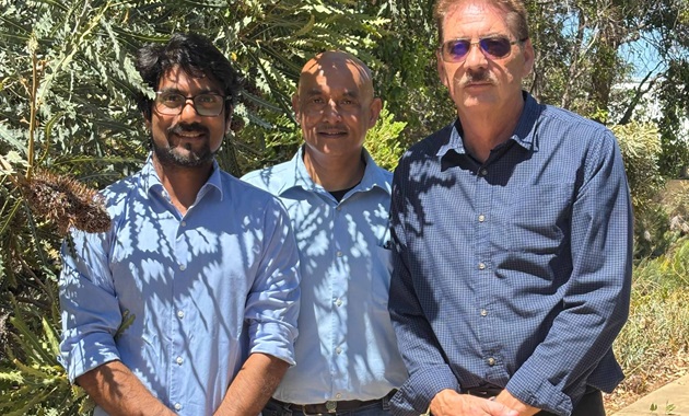 PhD candidate Fahad Halimand, Associate Professor Gérrard Eddy Jai Poinern and Senior Research Fellow, Derek Fawcett in front of a banksia tree.