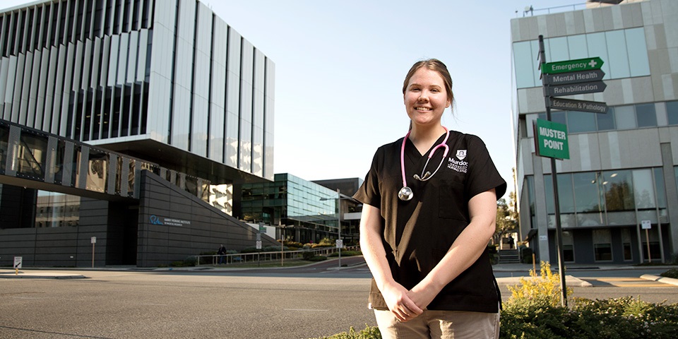 Female nursing student in front of hospital